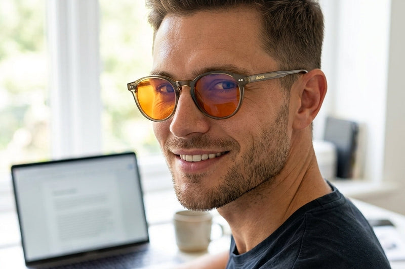 Auresta Aura amber-lens glasses on a desk in daylight