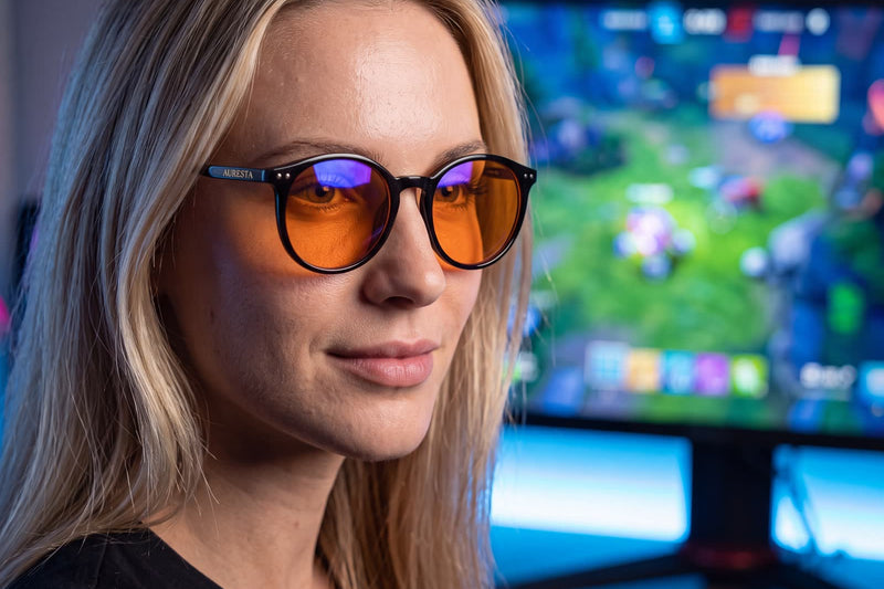 Auresta Raven amber-lens glasses beside a laptop in a home office
