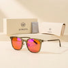 Olive blue light glasses with orange lenses beside the Auresta box, folding case and cleaning cloth